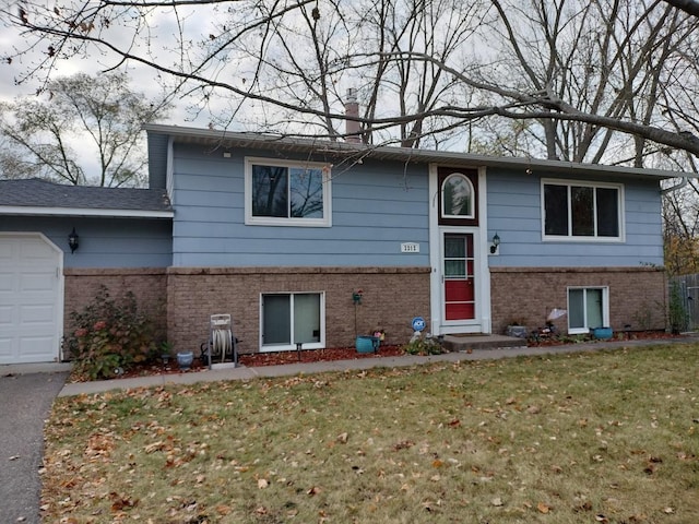 view of front of home with a garage and a front lawn