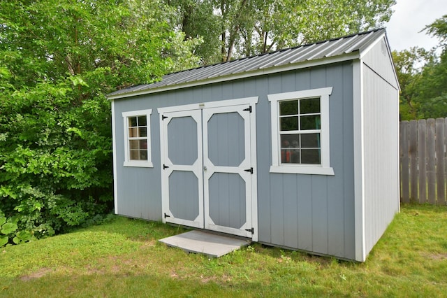 view of outbuilding featuring a lawn