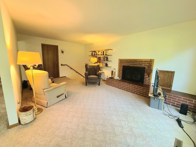 living area featuring carpet flooring and a fireplace