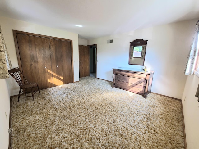 unfurnished bedroom featuring carpet floors and a closet