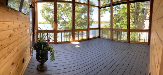 unfurnished sunroom with a water view