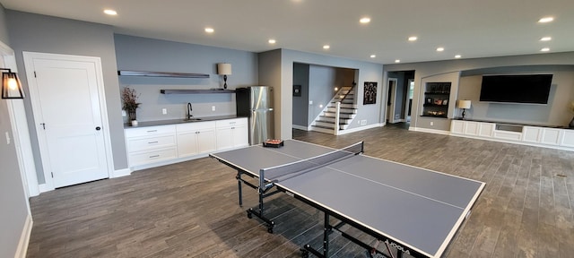 rec room with dark hardwood / wood-style flooring and sink