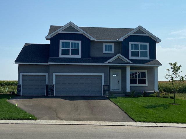 craftsman-style house featuring a garage and a front lawn