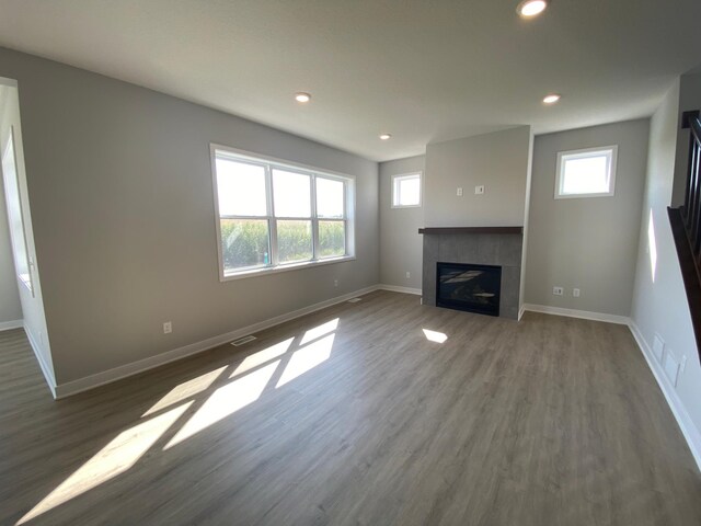 unfurnished living room featuring a fireplace and hardwood / wood-style floors