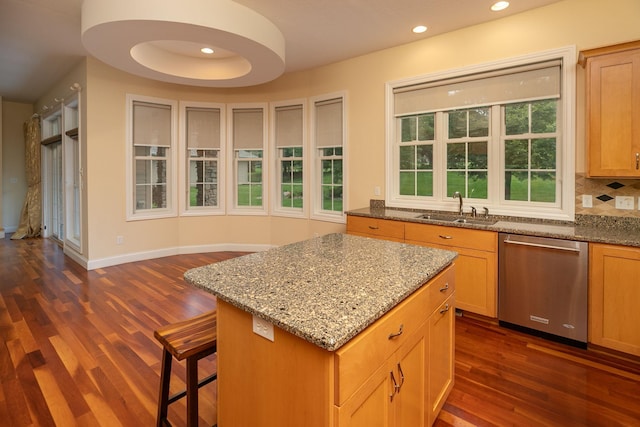 kitchen featuring light stone counters, dark wood-type flooring, sink, backsplash, and stainless steel dishwasher