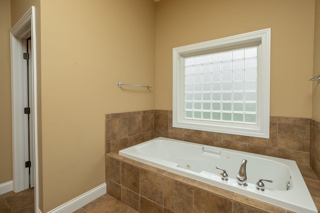 bathroom featuring tiled bath and tile patterned flooring