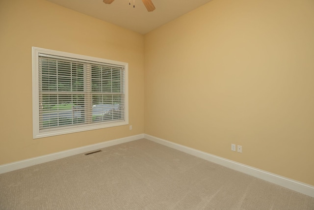 spare room featuring carpet and ceiling fan