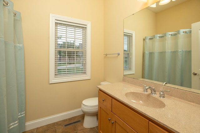 bathroom with curtained shower, vanity, toilet, and tile patterned floors