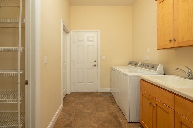 clothes washing area featuring cabinets, tile patterned flooring, washer and clothes dryer, and sink