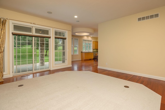 spare room featuring sink and dark hardwood / wood-style flooring