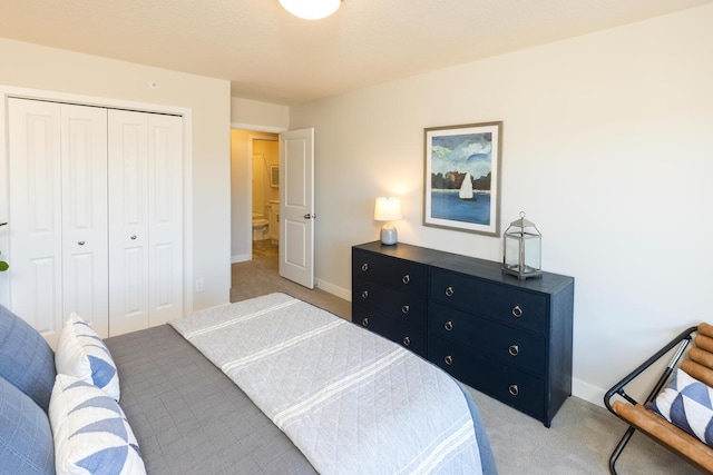 bedroom featuring a closet and light colored carpet