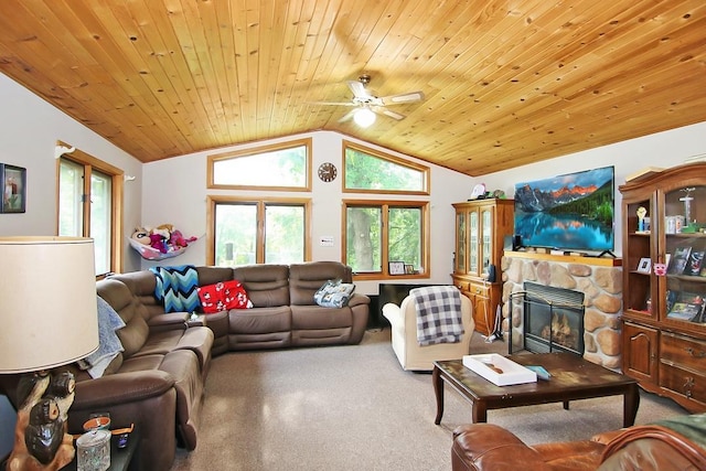 living room with ceiling fan, a stone fireplace, vaulted ceiling, and wooden ceiling