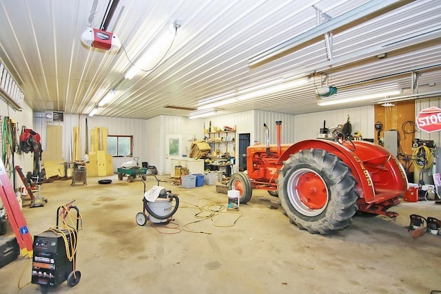 garage featuring a garage door opener and a workshop area