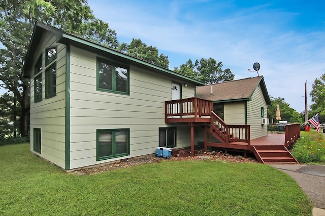 rear view of property with a deck and a lawn