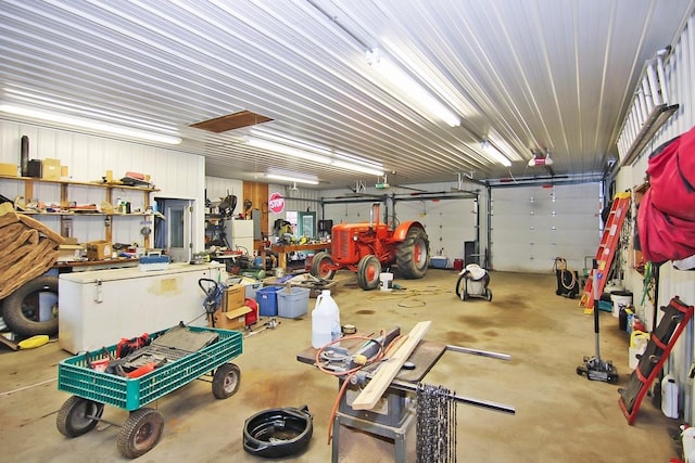 garage featuring a garage door opener and a workshop area