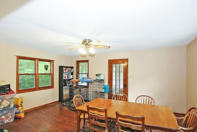 dining area featuring ceiling fan and dark hardwood / wood-style flooring