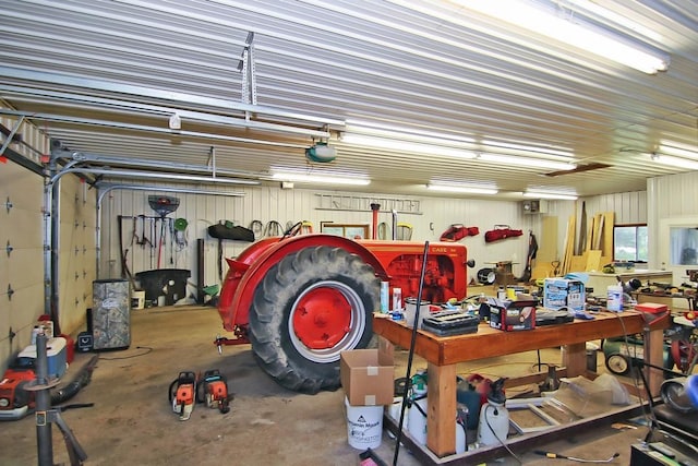 garage with a garage door opener and a workshop area