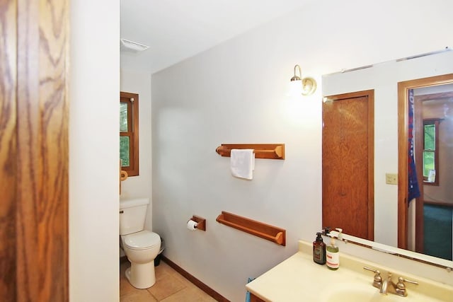 bathroom featuring vanity, tile patterned floors, and toilet