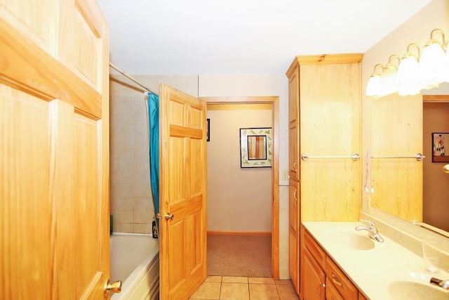 bathroom with tile patterned floors, shower / bath combo with shower curtain, and vanity