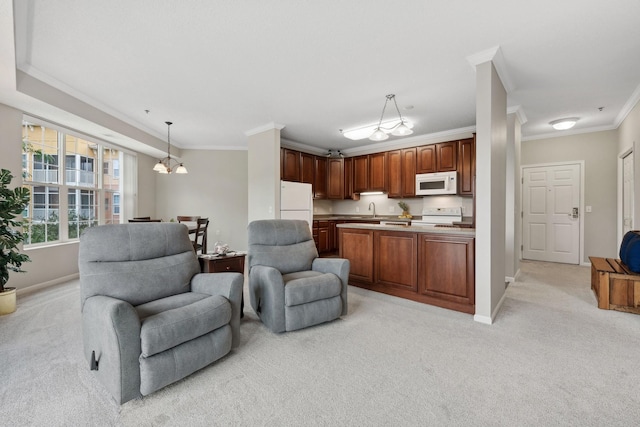 kitchen featuring a chandelier, ornamental molding, pendant lighting, light colored carpet, and white appliances