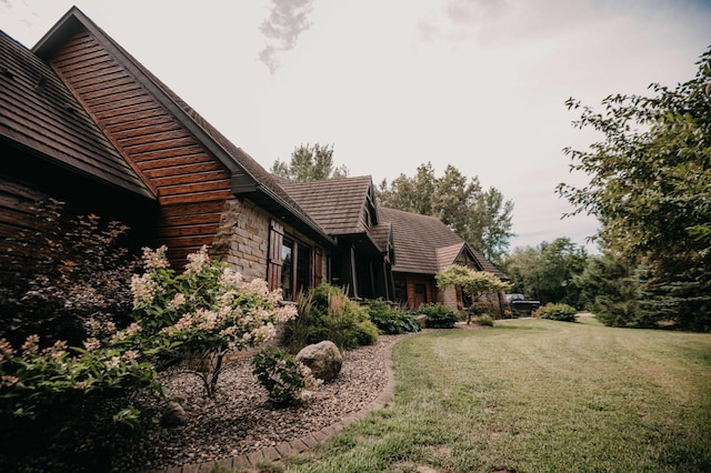 view of property exterior with a yard