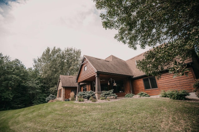 rear view of property featuring a yard