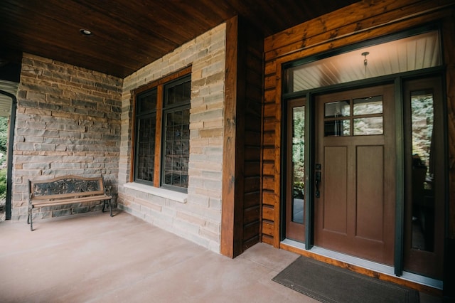 view of exterior entry with covered porch