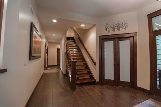 foyer entrance with dark hardwood / wood-style floors and french doors