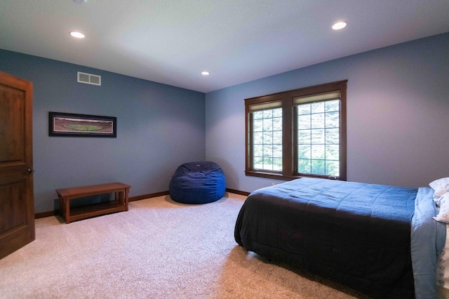 bedroom featuring light colored carpet