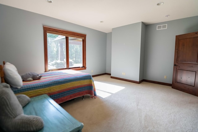 bedroom featuring light colored carpet