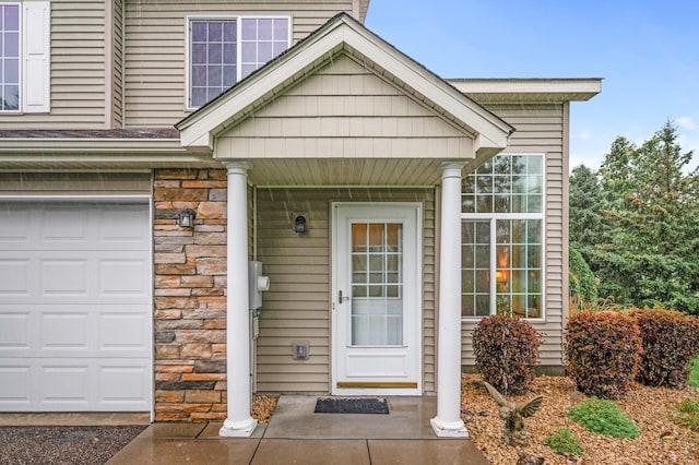 view of exterior entry featuring a garage