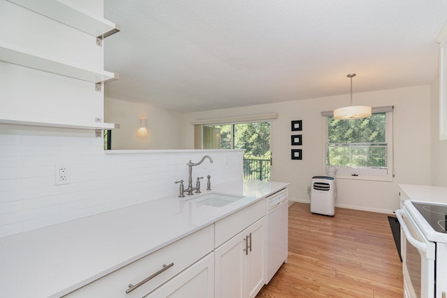 kitchen featuring a textured ceiling, white appliances, sink, light wood-type flooring, and white cabinets