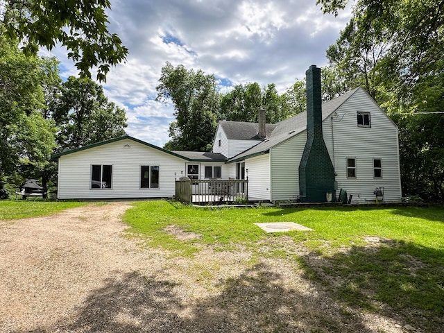 back of house featuring a yard and a deck