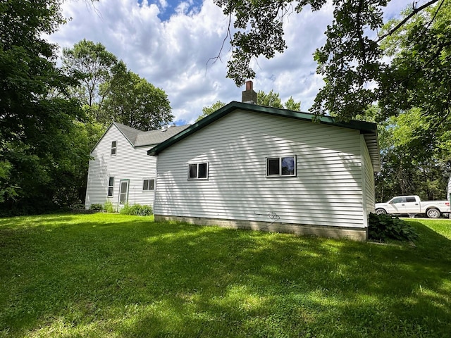 view of home's exterior with a lawn