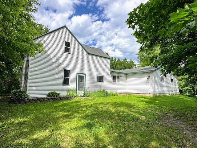 back of property with a lawn