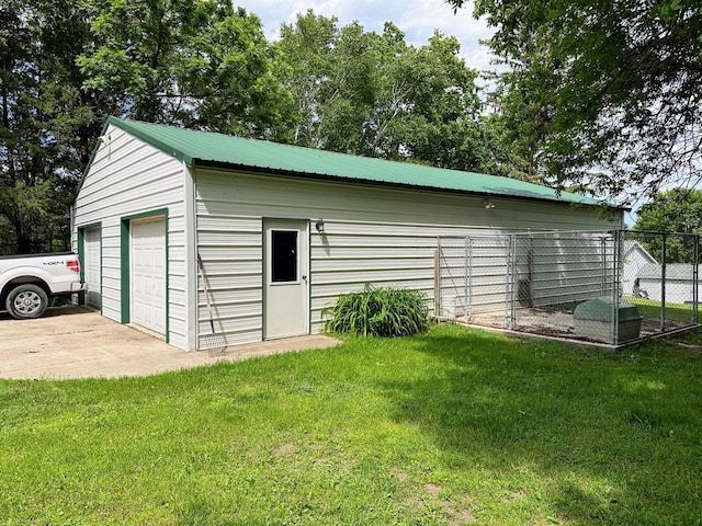 view of outbuilding with a garage and a lawn