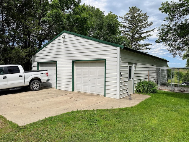 garage featuring a lawn