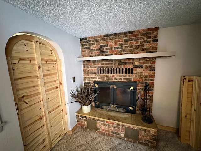 details featuring carpet flooring, a textured ceiling, and a fireplace