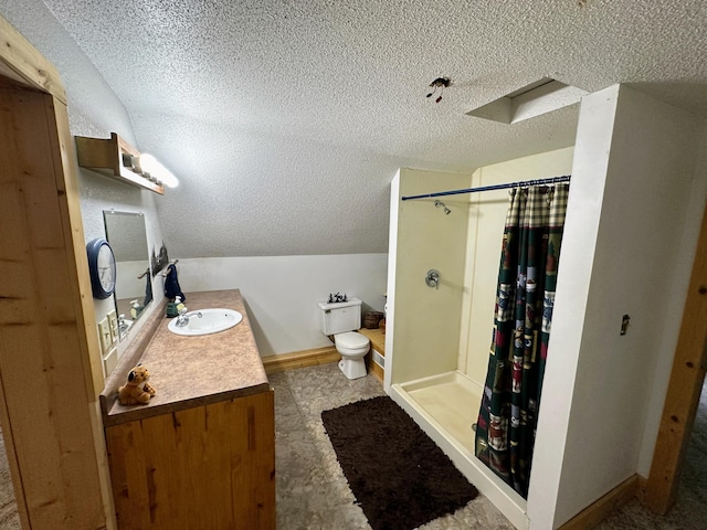 bathroom featuring vanity, lofted ceiling with skylight, toilet, a textured ceiling, and walk in shower