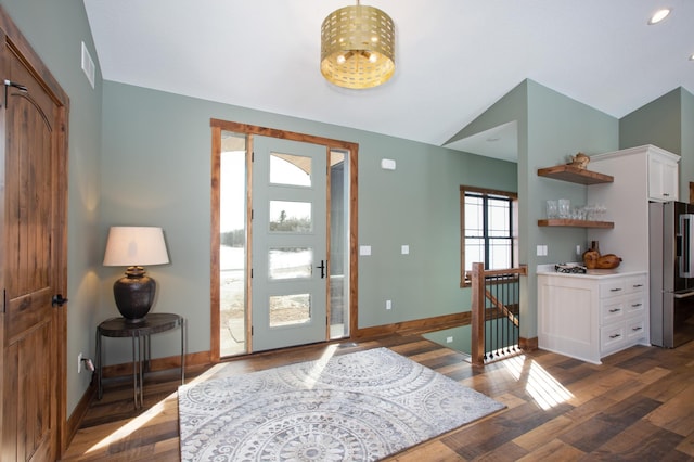 foyer with dark hardwood / wood-style flooring and vaulted ceiling