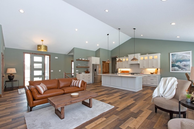 living room with sink, high vaulted ceiling, and dark wood-type flooring