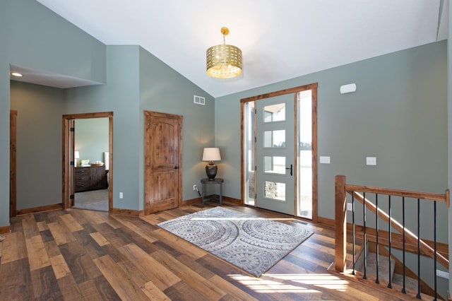 foyer entrance featuring high vaulted ceiling and hardwood / wood-style flooring