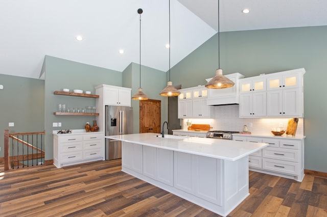 kitchen featuring white cabinetry, dark wood-type flooring, decorative light fixtures, and appliances with stainless steel finishes