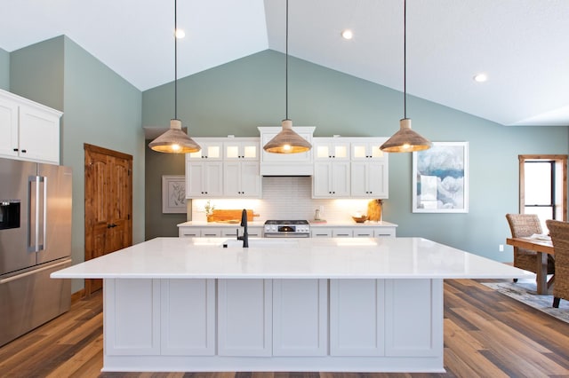 kitchen featuring a center island with sink, white cabinets, stainless steel appliances, and hardwood / wood-style flooring