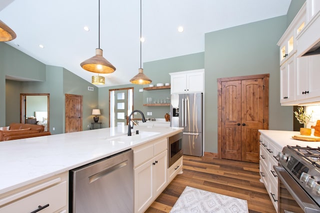 kitchen with sink, dark wood-type flooring, pendant lighting, white cabinets, and appliances with stainless steel finishes