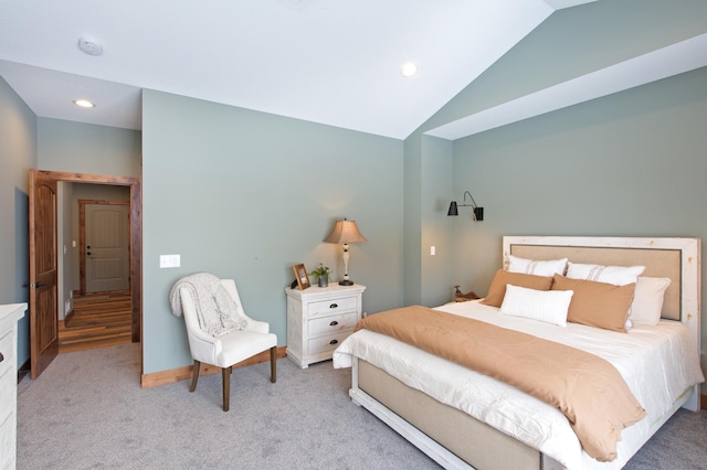 bedroom with light colored carpet and vaulted ceiling