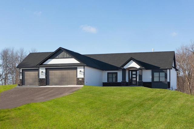 view of front of home with a garage and a front lawn