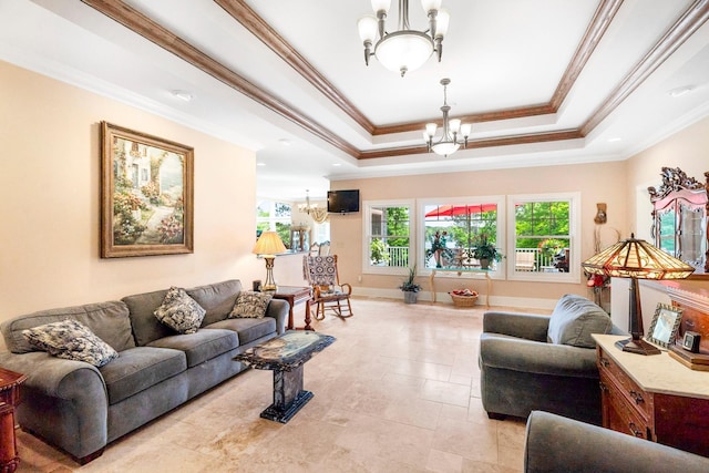 living area featuring ornamental molding, a tray ceiling, baseboards, and a notable chandelier