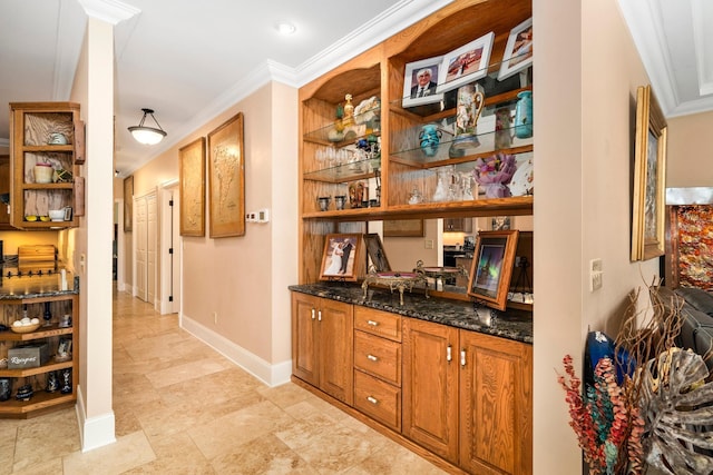 bar featuring ornamental molding and baseboards