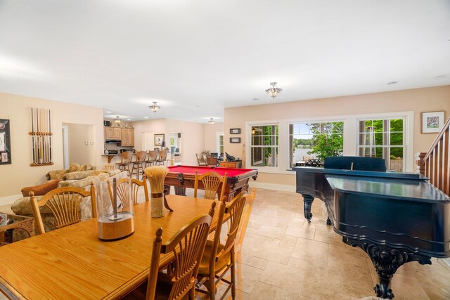 dining space featuring stone finish floor and baseboards